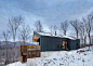 Quebec residence by Naturehumaine is
raised off a slope on a concrete podium