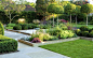 Good example of effectiveness of even a small change in elevation and attention to open and planted spaces, straight lines and rounded shapes.