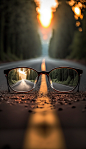 clear image of a road leading to a source of light behind an eyeglasses, with blur background