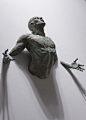 Matteo Pugliese bronze sculptures emerging/being engulfed? By white walls: 