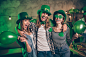 Close up photo buddies gathering company three friends cuddle anniversary tradition guys friends weekend vacation drunk funny funky specs casual outfit clothes saint paddy day festive