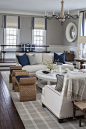 Crisp white sofas, navy blue accesories and natural ottomans VT Interiors - Library of Inspirational Images: 