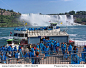 NIAGARA FALLS - AUGUST 2013:  Voyagers wearing blue raincoats board the Maid of the Mist tour boat to get up close to the falls as seen at Niagara Falls in August 2013.