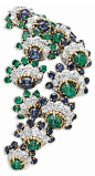 Van Cleef and Arpels / AN EMERALD, SAPPHIRE AND DIAMOND BROOCH/PENDANT, BY VAN CLEEF & ARPELS Designed as two rows of graduated clusters, half of them with cabochon emeralds in circular-cut sapphire and diamond partial border, half with cabochon sapph