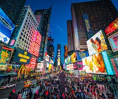 Times Square in New York City at duskTimes Square covered with illuminated billboards during the 'blue hour' period at dusk, with tourists on the streets.