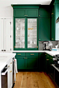 Dark green kitchen with white counters