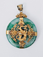 A big jade pendant with dragon mounting China, c. 1900. Bi-slice of jade enveloped by silver and gold plated metal in the centre with a dragon sourrounded by butterflys and blossoms. Unmarked. Diam.