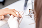 Manicurist painting finger nails by airbrush Manicure master is painting finger nails in beige color by airbrush in beauty salon nail airbrush stock pictures, royalty-free photos & images