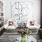 A painting by Al Held is displayed behind a pair of Warren Platner chairs by Knoll | archdigest.com