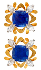 A pair of American Estate 18 karat gold and platinum “Flora Quadrant” ear clips with blue sapphires and diamonds by McTeigue & McClelland. The earrings have 2 cushion-cut blue sapphires with an approximate total weight of 2.80 carats, and 8 marquise-c