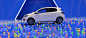 A white 2024 Mitsubishi Mirage Compact Hatchback parked in a blue stylized space. The ground is covered in colourful plastic balls. 