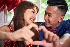 Lovely Asian couplePortrait of Asian young couple sitting together smiling to each other and gesturing