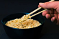 Person Holding a Chopsticks and Picking a Noodles in Black Bowl