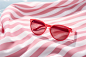 Pink saturday: the perfect summer sunglass to have in your bag, in the style of poolcore, joel robison, stripes and shapes, tabletop photography, light red and white, slumped/draped, moyoco anno