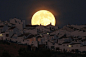 The Supermoon rises over houses in Olvera, in the southern Spanish province of Cadiz, July 12, 2014. Did you miss the Supermoon? See our gallery: http://reut.rs/U4OTGR

(Photo credit: REUTERS/Jon Nazca)