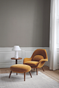 Space Copenhagen’s Swoon upholstered chair and ottoman with oak legs by <a href="https://www.fredericia.com/" target="_blank">Fredericia</a>.