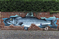 鱼作为涂鸦在砖墙上，吕内堡，下萨克森，德国，欧洲图片素材