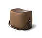 Ottoman Hermes ottoman with strap that makes it highly portable. L21.1" x H14.1" x W13.6". Storage area covered in chocolate leather.<br />Cover in taupe Palomino velvet.<br /><br />Recalling the shape of a saddle, the ott