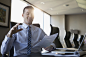 Smiling lawyer discussing paperwork and gesturing in conference room meeting by Hero Images  on 500px