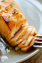 Close up Honey Mustard Baked Salmon with a fork ready to serve.