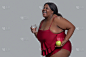 Dark-skinned woman holding an apple and a glass of