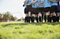 Middle school girl soccer team huddling on field by Hero Images  on 500px