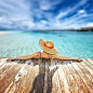 Woman in hat relaxing at beach jetty