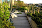 Walk-outs from both the master bedroom and living room access a 400 sq. ft. west-facing roof garden. Cast boulders and inset planters with alpines suggest landscape and add drama to the background, which includes additional planters filled with a variety 