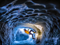 Photo: An ice climber scales a cave wall in Chamonix, France