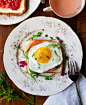 Breakfast toast with fried egg, tomato, and herbs