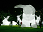 Illuminated inflatable white rabbits by Australian artist Amanda Parer for an installation entitled Intrude.