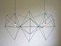 This Geometric/ Industrial chandelier adds shape and line to the space