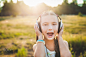 beautiful girl listening music with headphones and singing