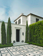 This front courtyard, comprised of black Belgian cobblestones and white pebbles, replicates a rustic plaza designer Daniel Cuevas fell in love with in Madrid.