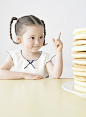 Canadian girl counting piling pancakes on table