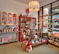 Light and feminine display of gift ideas. I want the polka dot tea kettle on the top shelf~