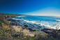 Rocks on Seashore Under Blue Sky