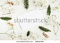 Craft paper writing background, framed flowers, pine tree twigs, decor festive mock up. Light white and green tones, soft focus. Place for text. 