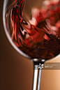 Red wine pouring in glass创意图片素材 - The Image Bank