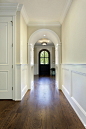 Example of a mid-sized classic medium tone wood floor entryway design in Chicago with beige walls and a dark wood front door