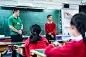 Teacher looking at schoolboy against blackboardSmiling male teacher looking at teenage schoolboy in classroom. Student and instructor are standing against blackboard. They are in high school building.