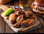 stock-photo-crispy-barbecue-chicken-wings-with-celery-on-wooden-serving-tray-139834265