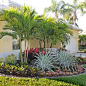 Photo of a mid-sized tropical partial sun front yard brick landscaping in Miami.