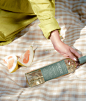 girl holding avaline white wine bottle on the blanket