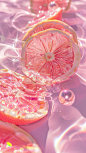 This may contain: a grapefruit cut in half sitting on top of water with bubbles around it