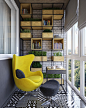 And finally, out on the terrace with an open view, you'll find shelving and a bright yellow chair along with bold tire work - all set against exposed brick. Exposed brick in this space as a whole has always been used as an accent, tying together all of th