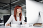 Businesswoman with computer in her office at the desk, working.