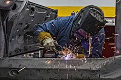 Welder Uses Torch on Car He is WeldingMan is welding vintage Porsche car frame with sparks flying. SDF