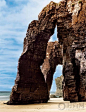 西班牙大教堂海滩高耸的拱门状巨石