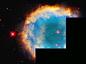 Red-orange and yellow ring the turquoise center of this spherical planetary nebula